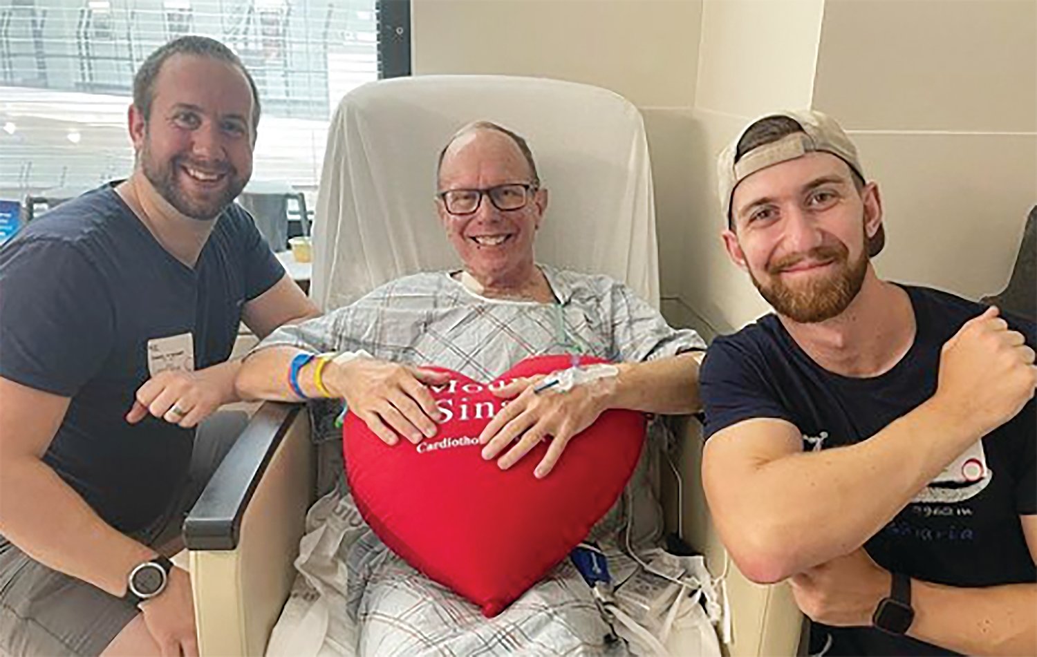 In this photo from Father Henry Zinno’s Instagram account, the pastor of Our Lady of Mount Carmel in Bristol holds up a stuffed heart in the cardiac unit of Mount Sinai Hospital. He is joined by his nephews, Kevin and Danny.